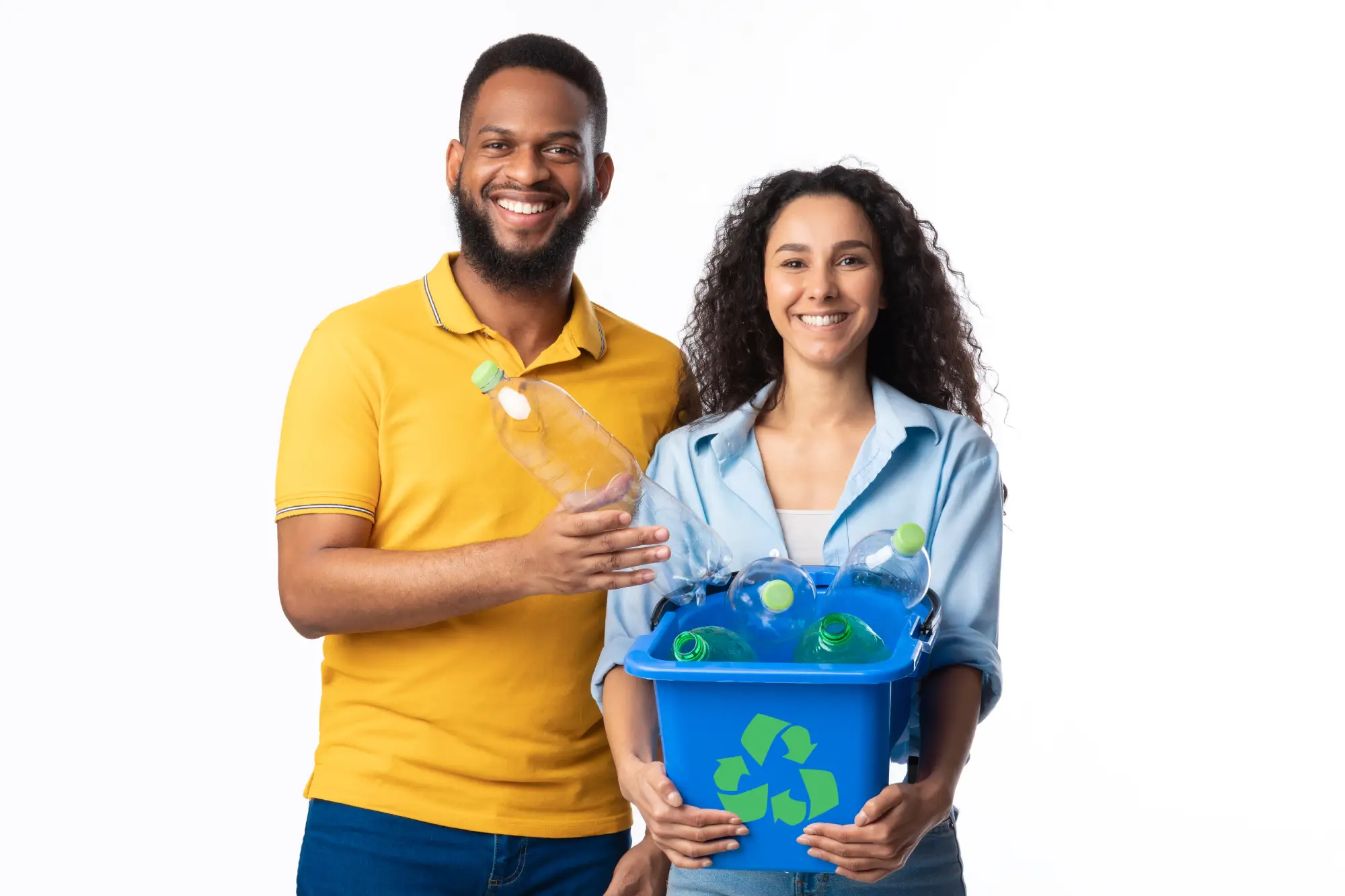 Two smiling volunteers holding a recycling bin filled with plastic bottles